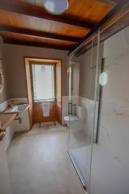 a bathroom with a glass shower and a sink at CASA CON ENCANTO (o Refuxio) in Merza