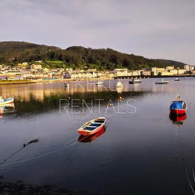 three boats are docked in a body of water at Indiano 5B in Viveiro