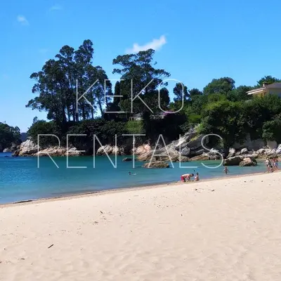 a beach with a sign that says love on it at Indiano 5B in Viveiro