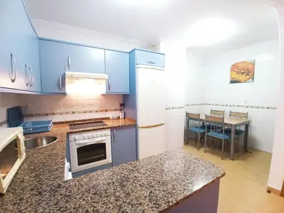 a kitchen with blue cabinets and a counter top at Indiano 5B in Viveiro