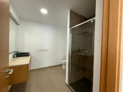 a bathroom with a toilet and a glass shower at ARZUAWAY in Arzúa
