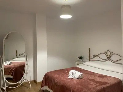 a bedroom with two beds and a mirror at ARZUAWAY in Arzúa
