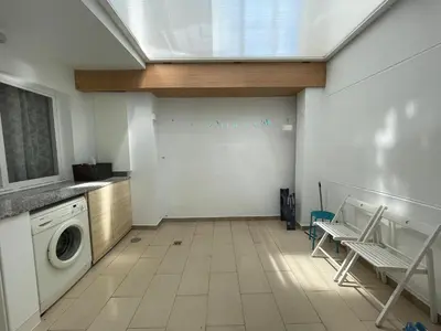 a laundry room with a washing machine and a window at ARZUAWAY in Arzúa