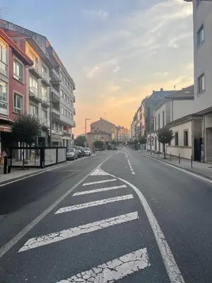an empty street in a city with buildings at ARZUAWAY in Arzúa