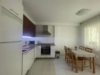 a small kitchen with a table and a table and chairs at ARZUAWAY in Arzúa