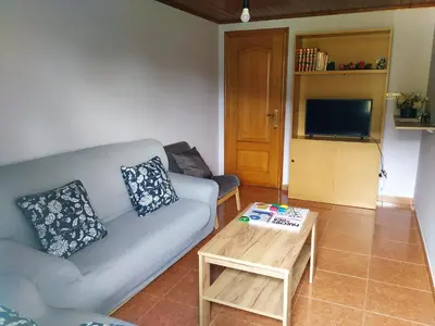 a living room with a couch and a coffee table at Casa Xancin in Ribadeo