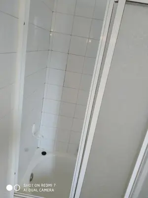 a shower with a glass door in a bathroom at Hostal padornelo in Mondoñedo