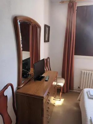 a room with a desk with a computer and a mirror at Hostal padornelo in Mondoñedo