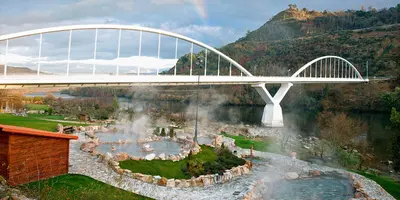 a bridge with a waterfall and a waterfall at O Fogar de Cati in Ourense