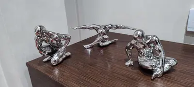 three metal sculptures sitting on top of a wooden table at O Fogar de Cati in Ourense