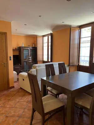 a dining room and living room with a table and chairs at Apartamento Vila O Valadouro 2 in O Valadouro