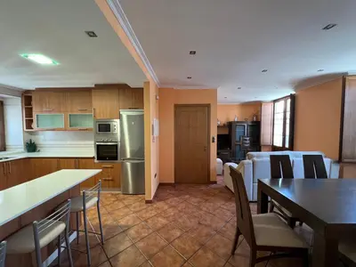 a kitchen and living room with a table and chairs at Apartamento Vila O Valadouro 2 in O Valadouro