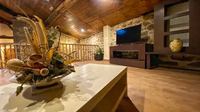 a living room with a vase of flowers on a table at Casa do Veiga in Chantada