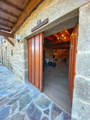 an entrance to a stone building with a wooden door at Casa do Veiga in Chantada