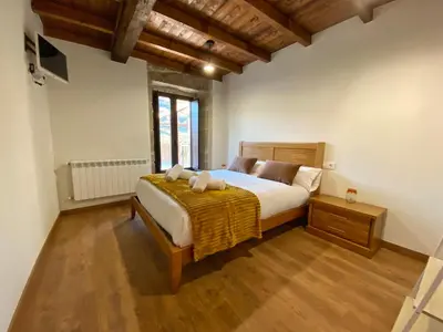 a bedroom with a bed with two stuffed animals on it at Casa do Veiga in Chantada