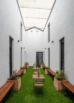 a row of tables and benches in a building at Dpaso hostel in Chantada
