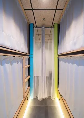 a room with two windows with white curtains at Dpaso hostel in Chantada