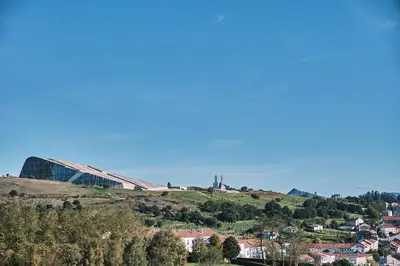 a building on top of a hill with a city at ALDARA SUITES in Santiago de Compostela