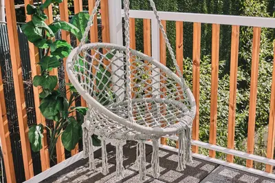 a white swing chair sitting on a porch at ALDARA SUITES in Santiago de Compostela