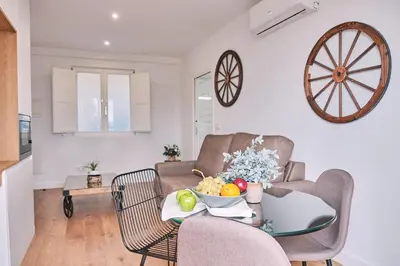 a living room with a table with a bowl of fruit on it at ALDARA SUITES in Santiago de Compostela