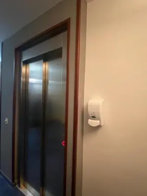 a elevator in a room with a mirror at HOSTAL CASA JULIO - Auto Check-in in Culleredo
