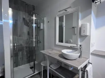 a bathroom with a sink and a shower at HOSTAL CASA JULIO - Auto Check-in in Culleredo