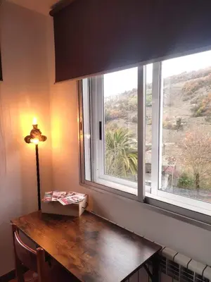 a window with a wooden table in front at Casa Loureira - Ribeira Sacra in Rosende