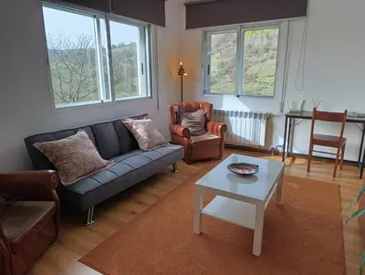 a living room with a couch and a table at Casa Loureira - Ribeira Sacra in Rosende