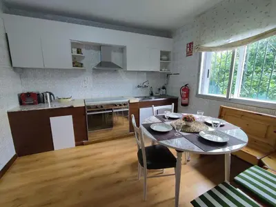 a kitchen with a table and a dining room at Casa Loureira - Ribeira Sacra in Rosende