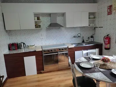 a kitchen with a table and a dining room at Casa Loureira - Ribeira Sacra in Rosende