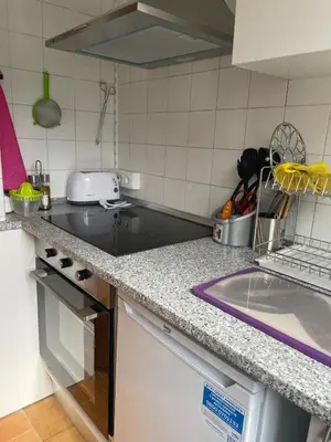 a kitchen with a counter top with a sink at Casa da Fontiña in Seoane