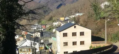 a white house on the side of a mountain at Casa da Fontiña in Seoane