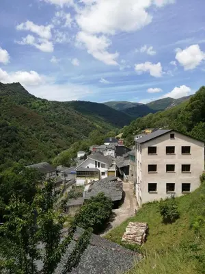 a group of buildings in a valley with mountains at Casa da Fontiña in Seoane