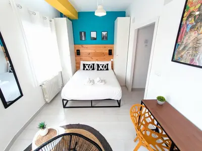 a small room with a bed and a chair at XOXO - Arco in Ponferrada