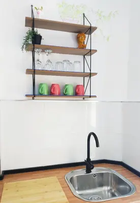a kitchen counter with a sink and shelves at XOXO - Arco in Ponferrada