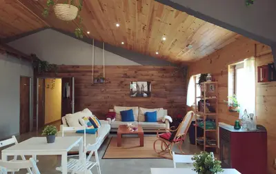 a living room with a couch and a table at Albergue A Nave de Ferreira in Lugo