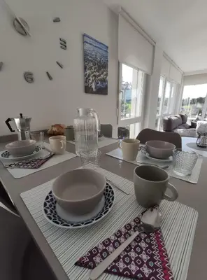 a dining room table with bowls and dishes on it at Foz, ven y disfruta Galicia in Foz
