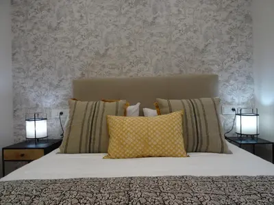 a bedroom with a bed with two lamps on tables at Mi Refugio in Monforte de Lemos