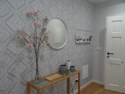 a room with a mirror and a table with a vase at Mi Refugio in Monforte de Lemos