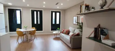 a living room with a table and a couch at Mi Refugio in Monforte de Lemos