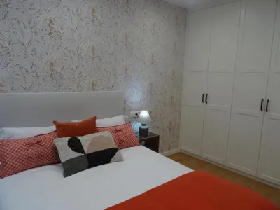 a bedroom with a white bed with red pillows at Mi Refugio in Monforte de Lemos