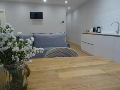 a living room with a table with a vase of flowers at Mi Refugio in Monforte de Lemos