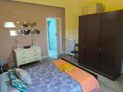 a bedroom with a large bed and a dresser at La Puebla in Ponferrada