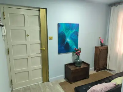 a room with a door and a painting on the wall at La Puebla in Ponferrada