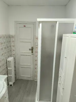 a bathroom with a white door and a sink at La Puebla in Ponferrada