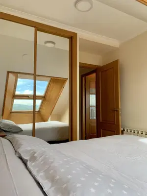 a bedroom with a large bed and a window at MODERNO PISO CON LA MEJOR TERRAZA DE RIBADEO Y VISTAS MARAVILLOSAS in Ribadeo