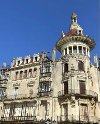 an old building with a tower on top of it at MODERNO PISO CON LA MEJOR TERRAZA DE RIBADEO Y VISTAS MARAVILLOSAS in Ribadeo