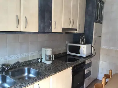 a kitchen with a sink and a microwave at Casa Tino in Montederramo