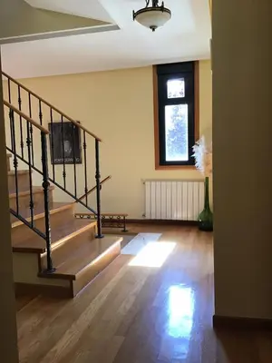 a room with a staircase with a tv on the wall at Casa Tino in Montederramo
