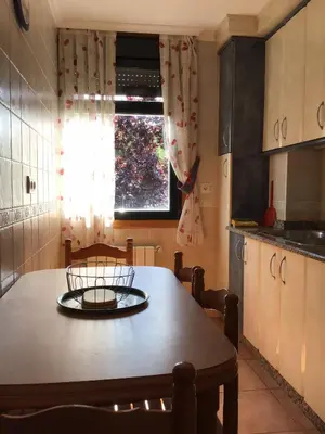 a kitchen with a table and a window at Casa Tino in Montederramo